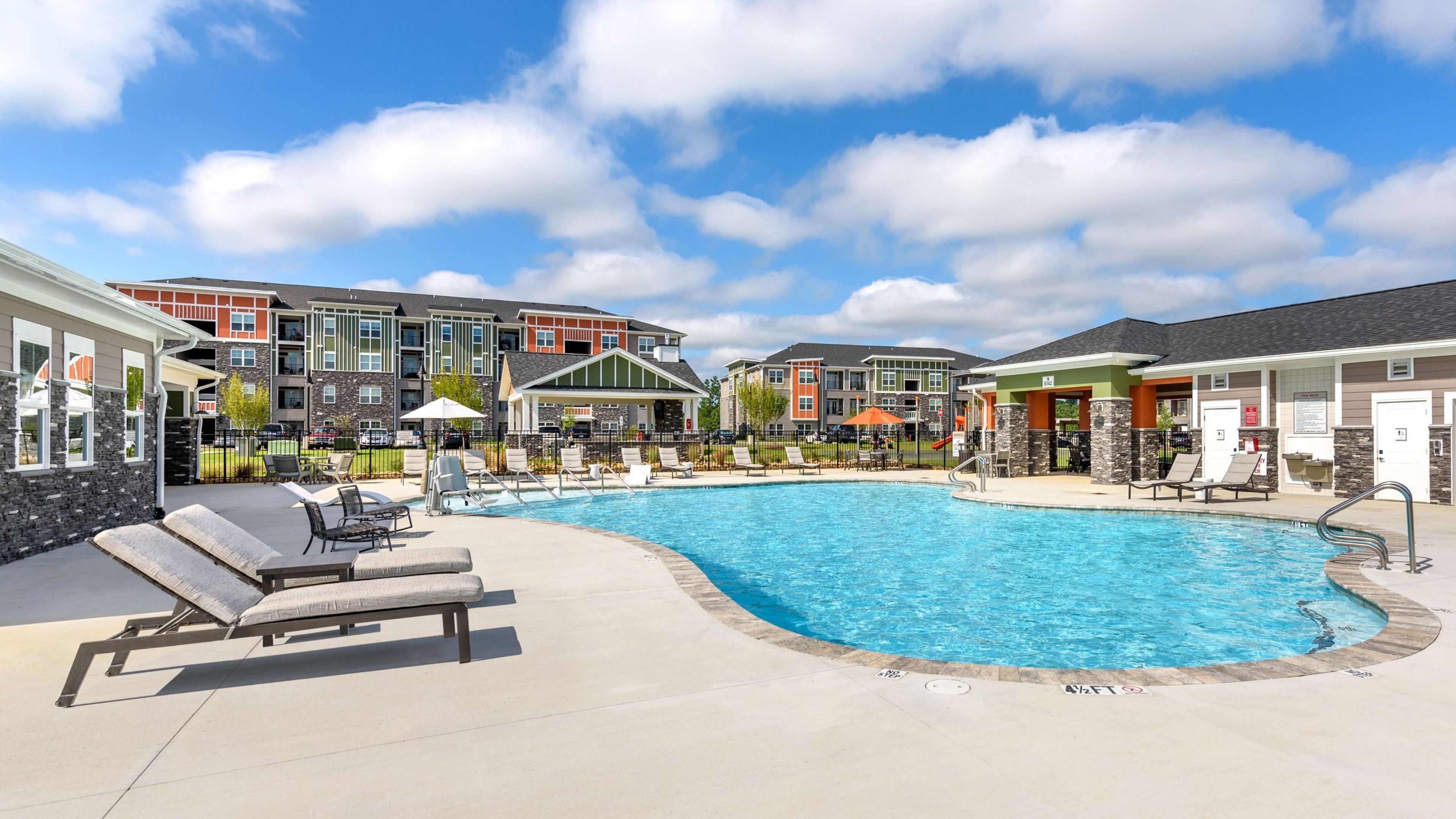 Hawthorne at the Crest outdoor luxury pool amenity for residents, surrounded by lounge chairs