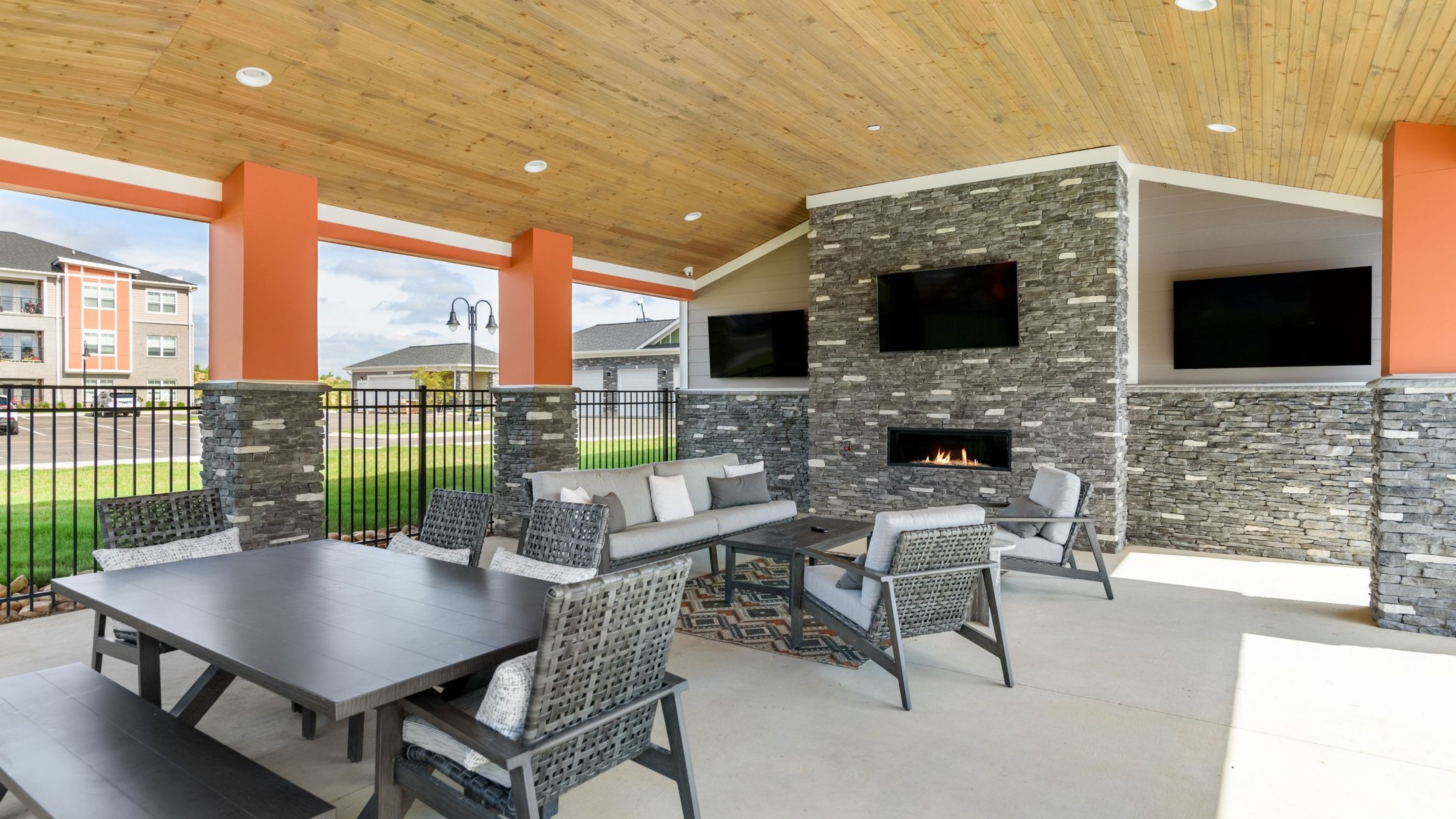 Hawthorne at the Crest outdoor amenity area with fireplace, seating, and large TV