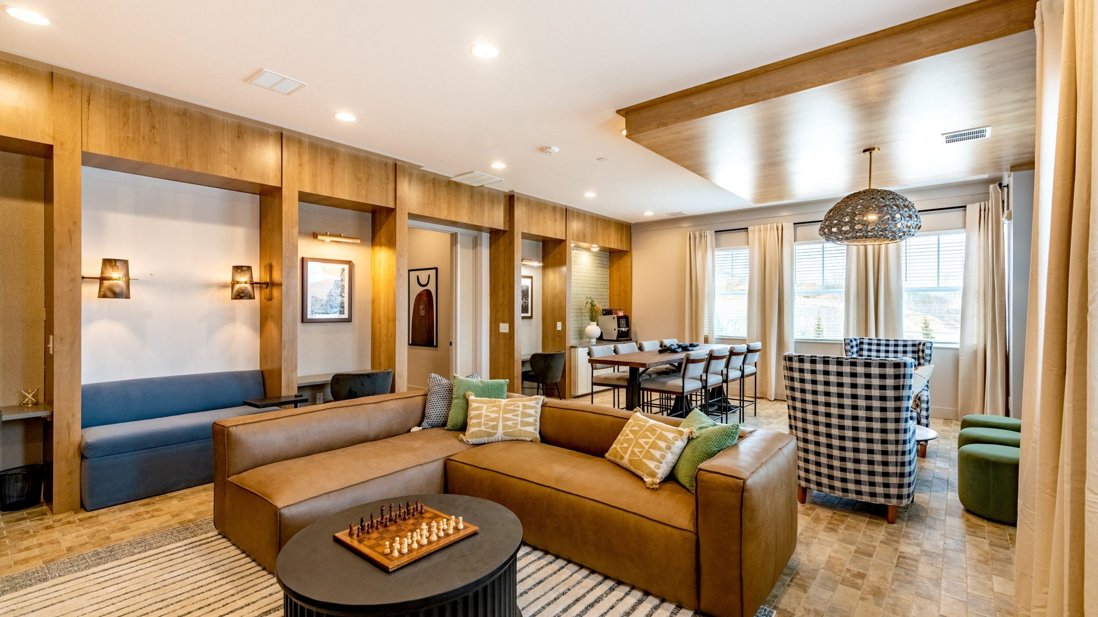 Hawthorne at the Crest beautiful clubhouse amenity for residents with booth, couch, and table seating