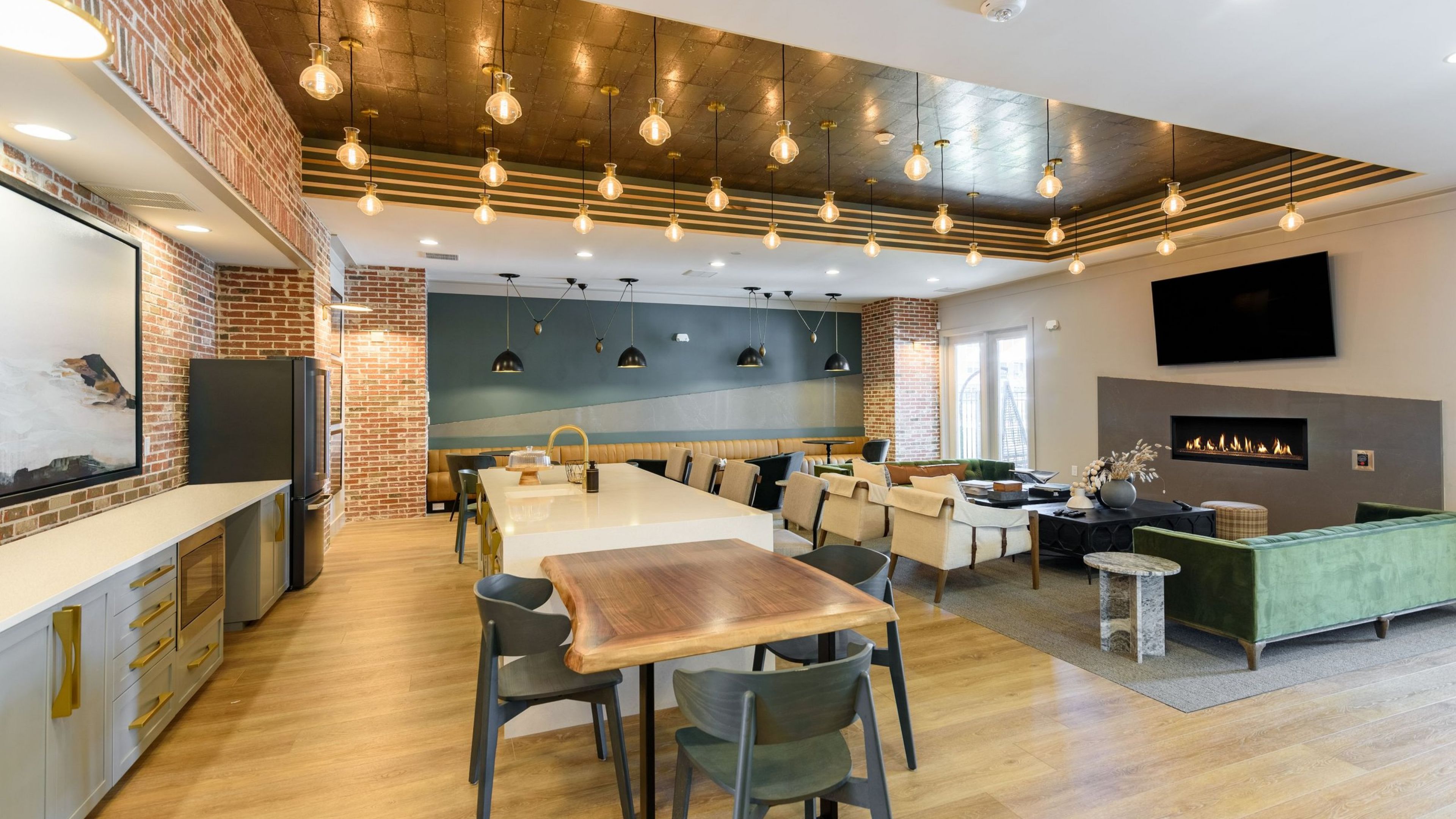 Hawthorne at the Crest resident clubhouse with entertainment space and kitchen, fireplace, and seating areas